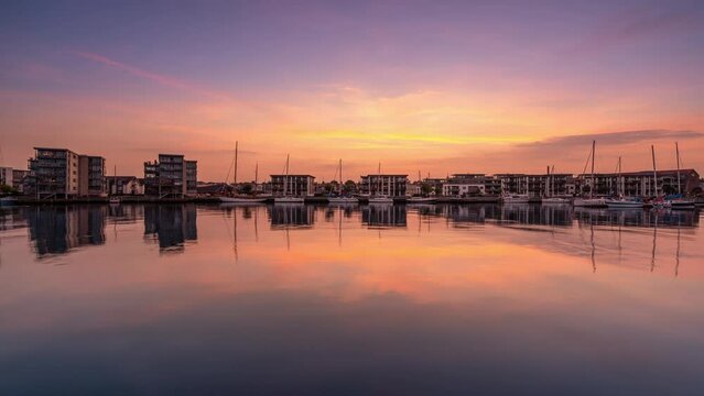 A colourful sunset at the marina with the new residential building in Nyborg on the island of Funen in Denmark