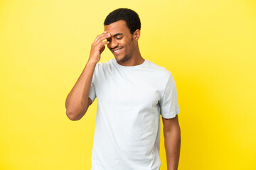 African American handsome man on isolated yellow background laughing