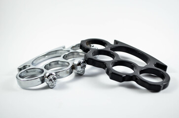 Obraz premium Two Brass Knuckles On The Isolated White Background