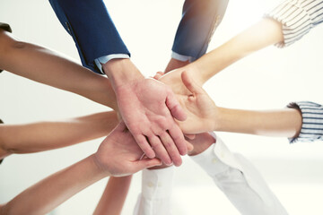 Well conquer together. Closeup shot of a group of businesspeople joining their hands together in unity.