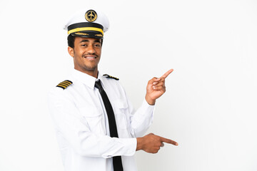 African American Airplane pilot over isolated white background pointing finger to the side and presenting a product © luismolinero