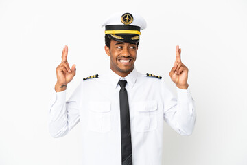 African American Airplane pilot over isolated white background with fingers crossing