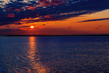 Glowing sunset over the wadden sea between Borkum and Juist, East Frisian Islands, Germany.