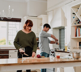 Nothing tastes better that a meal made with love. Cropped shot of a couple cooking together in the kitchen at home.