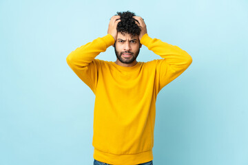 Young Moroccan man isolated on blue background doing nervous gesture