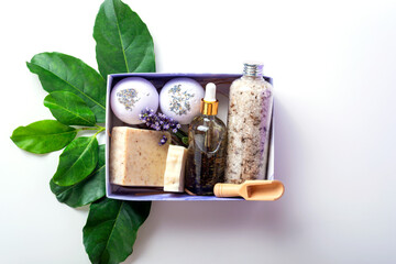 Lavender pamper gift box on green leaves as a concept of natural cosmetic and spa products.