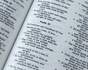 Psalm 33, greatness and goodness of God Jesus Christ, Old Testament Scripture. An open Holy Bible...