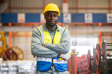 Portrait of happy maintenance worker with confident service at factory warehouse.
