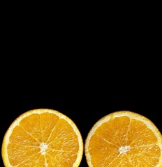 orange slices on the black background with copy space. 