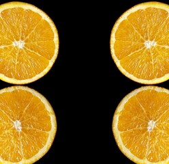 orange slices on the black background with copy space. 