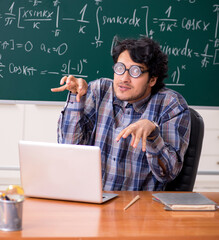 Funny male math teacher in the classroom
