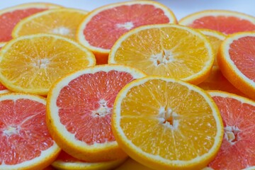 Naklejka na ściany i meble Orange slices with slices of red oranges