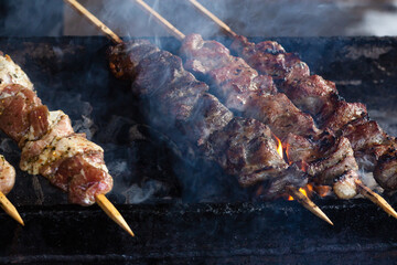 Marinated shashlik preparing on a barbecue grill over charcoal. Shashlik or Shish kebab popular in Russia. Roast Beef Kebabs On BBQ Grill.Appetizing, fragrant, smoky piece of meat