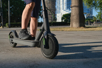 Unrecognizable man with his electric kick scooter in the city, eco transport © Carolina Jaramillo