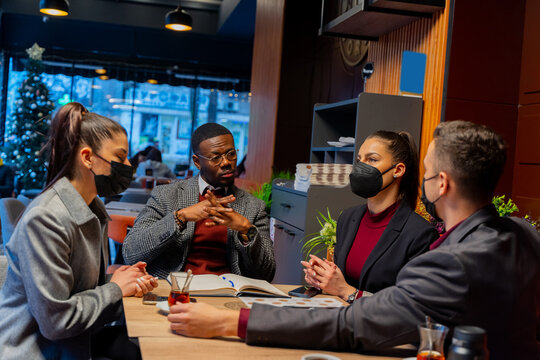 Having a conversation with their masks on about the business