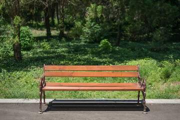 Orange wooden bench in the city park.