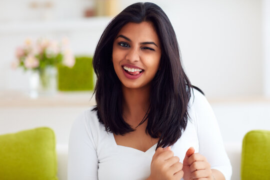 portrait of beautiful funny indian woman having fun at home
