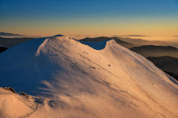 Fototapeta na wymiar view of Chleb in Mala Fatra on snowy slopes during sunrise