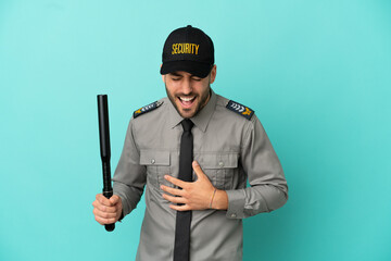 Young security man isolated on blue background smiling a lot