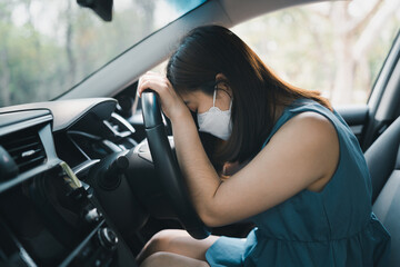 Asian woman napping in her car caused of tired from workload or feeling sleepy. Woman driver...