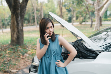 Asian woman calling garage after car breaks down. woman opening car hood and call to insurance or...
