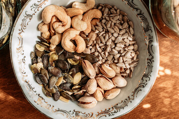 Cashew nuts, pistachios, sunflower and pumpkin seeds in a bowl on the table.