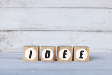 Idee concept written on wooden cubes or blocks, on white wooden background.