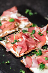 Bread slice with cream cheese and prosciutto ham