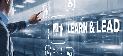 Learn and Lead. Businessman presses hand on the virtual screen inscription