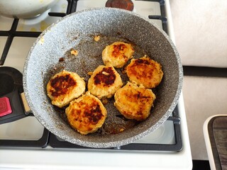 Chicken cutlets in a pan on the stove
