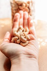 Hand holding cashew nuts. Healthy eating, snacks