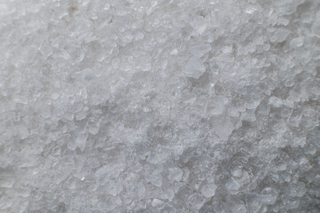 Coarse white iodized salt. Detailed background texture Macro close-up. Salt crystals of different sizes