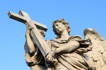 Naklejka premium Angel with the Cross Statue on the Ponte Sant'Angelo Bridge in Rome, Italy