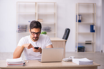 Young male student employee at workplace