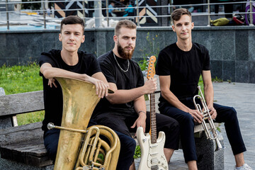 Young street music band play a lot of musical instruments