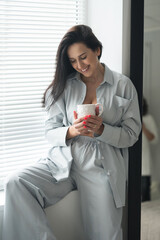 beautiful brunette adult girl in femine pajamas sleep wear homewear at home lifestyle