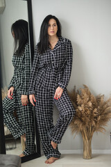 beautiful brunette adult girl in femine pajamas sleep wear homewear at home lifestyle