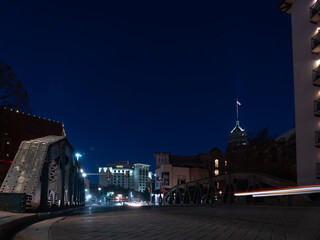Low Angle Long Exposure Picture of San Antonio Bridge With American Flag on the Wind of High Building