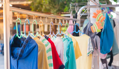 Colorfull Baby clothes dry morning sunlight on the clothes line.