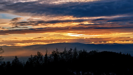 Sunset with dramatic cloudy sky over mountains shape, beautiful nature landscape