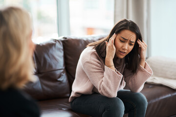 I feel trapped inside my mind. Shot of a young woman having a therapeutic session with a psychologist.