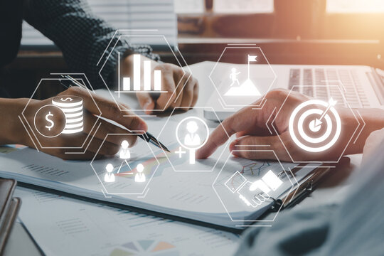 Business team discussing data with document data with VR screen quality management icon on desk table, Standardisation and certification concept.