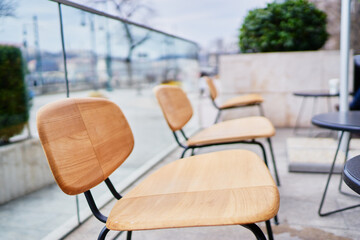 The wooden chairs in sidewalk cafe.