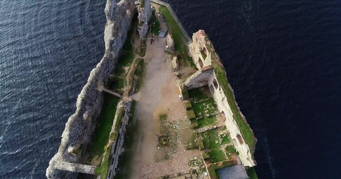 Aerial view of an old stone castle ruins in Koknese, Latvia. Located on a peninsula near the Daugava river and Perse river.