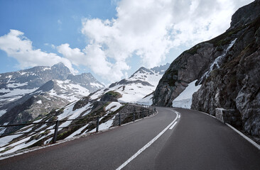 Asphalt road in Alp mountains. Road trip concept. Beautiful landscape.