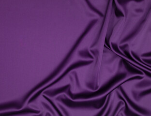Abstract background with copy space - purple fabric with folds.