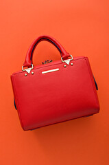 Red handbag on an orange background, Stylish side bag, Leather bag, orange background, Minimalism
