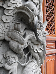 Ngong Ping, Hong Kong, China - September 17 2019: Po Lin monastery stone dragon carved pilar. Dragons in Chinese culture symbolize great power, good luck and strength