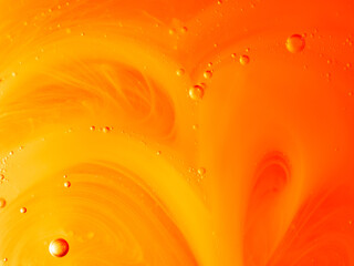 Yellow and orange background with bubbles and a pattern made with liquid soap, abstract image, horizontal