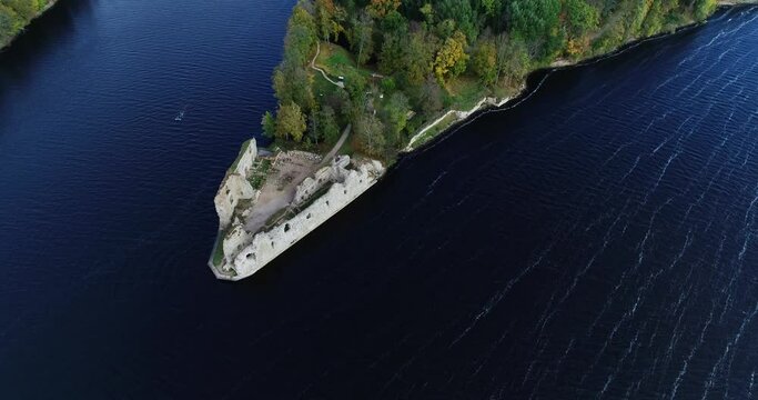Aerial view of an old stone castle ruins in Koknese, Latvia. Located on a peninsula near the Daugava river and Perse river.